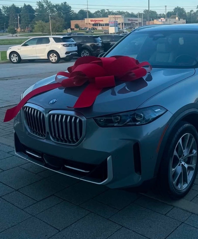 2026 BMW SUV with a celebratory red bow, Anariya W.